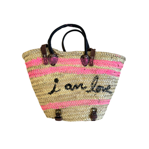 Hand-painted straw tote bag with neon pink stripes, 'i am love' script, and leather handles by Kerri Rosenthal