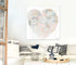 Heart-shaped abstract art print on a wall above an outdoor area with sofa with decorative pillows.