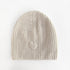The cream cashmere beanie hat with ribbed knit and a heart patch - Shop cute women’s beanies and hats by Kerri Rosenthal