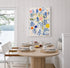 Colorful contemporary abstract butterfly painting by Kerri Rosenthal styled in a modern dining room