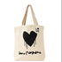 A cream-colored canvas tote bag with a black dripping heart graphic and the word 'LOVE' printed in a white square on the upper right side. The bag has two beige shoulder straps and a black script graphic underneath the heart.