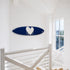 Kerri Rosenthal navy heart surfboard mounted horizontally on a wall near a staircase landing
