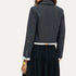Close-up back detail of a navy pinstriped cropped blazer with yellow heart-stitched elbow patches and tie-dye cuff lining by Kerri Rosenthal