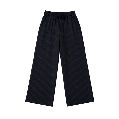 Flat lay of black pinstripe pants.