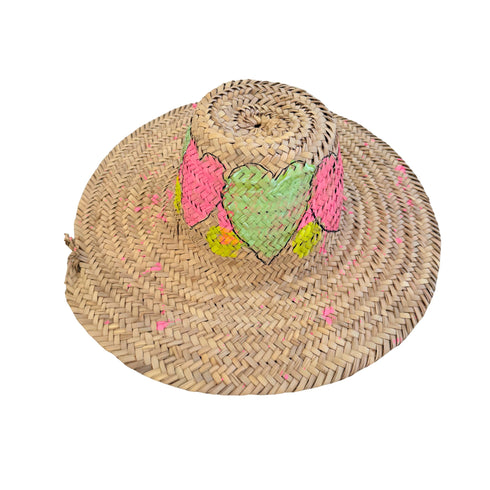 Woven straw lifeguard hat hand-painted with pink and green heart designs around the crown and pink paint fleck accents throughout — Kerri Rosenthal wearable art