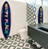 Bathroom with surfboards on the wall, one displaying 'Happy Place'.