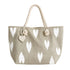 A canvas tote bag in a light taupe-beige color with a white ikat heart pattern, featuring thick cream-colored rope handles and a small heart-shaped charm.