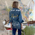 Women's denim button-down blue shirt made from 100% cotton featuring hand-painted work of heart artwork with drip designs created in Kerri's studio