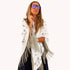 Woman wrapped in a cream fringed poncho with a heart pattern