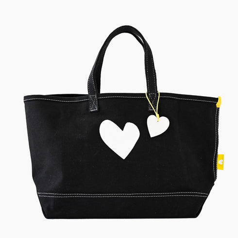 Imperfect heart black canvas tote is an everyday essential made from cotton with a heart graphic and heart charm - Shop cute tote bags by Kerri Rosenthal