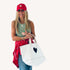The Imperfect Heart white canvas tote bag is a classic Kerri piece. Gently structured, bag charm, fits your laptop and spare flats - Shop cute totes by Kerri Rosenthal.