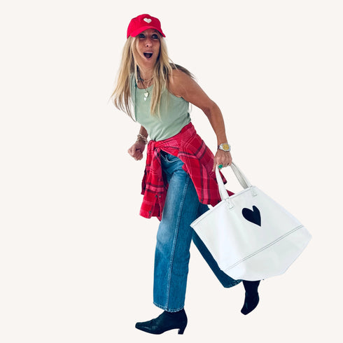 The Imperfect Heart white canvas tote bag is a classic Kerri piece. Gently structured, bag charm, fits your laptop and spare flats - Shop cute totes by Kerri Rosenthal.