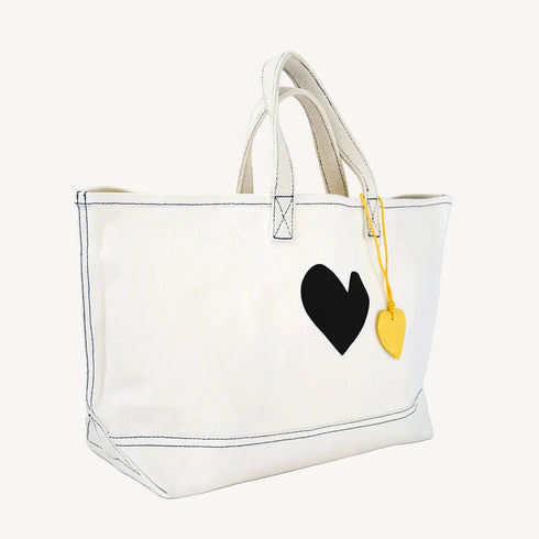 The Imperfect Heart white canvas tote bag is a classic Kerri piece. Gently structured, bag charm, fits your laptop and spare flats - Shop cute totes by Kerri Rosenthal.