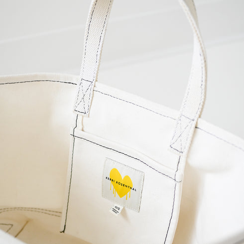 Imperfect heart white canvas tote is an everyday essential made from cotton with a heart graphic and heart charm - Shop cute tote bags by Kerri Rosenthal