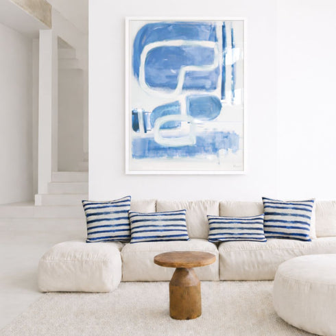 Indigo blue maze wall art print artwork and stripe decorative throw pillow on couch by Kerri Rosenthal