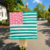 Original hand-painted American flag artwork with pink, white heart stars, and teal brushstroke stripes, held outdoors on a sunny summer day.