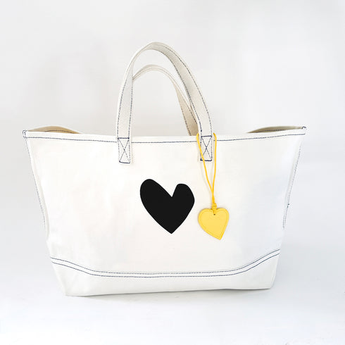 The Imperfect Heart white canvas tote bag is a classic Kerri piece. Gently structured, bag charm, fits your laptop and spare flats - Shop cute totes by Kerri Rosenthal.