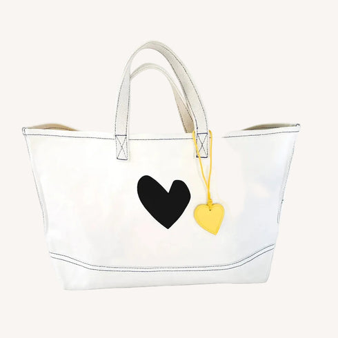 The Imperfect Heart white canvas tote bag is a classic Kerri piece. Gently structured, bag charm, fits your laptop and spare flats - Shop cute totes by Kerri Rosenthal.