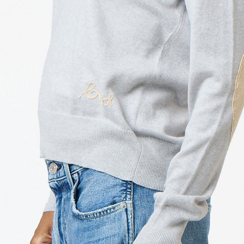 Grey patchwork crewneck sweater with imperfect heart patches on elbows in a soft cotton-cashmere blend. Cute women's sweaters by Kerri Rosenthal