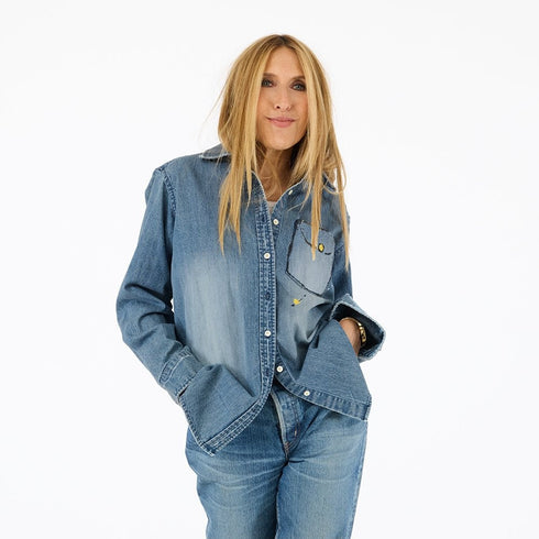 Women's denim button-down blue shirt made from 100% cotton featuring hand-painted work of heart artwork with drip designs created in Kerri's studio