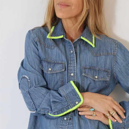 Fresh twist on a classic Western denim shirt with bold green stitching chest pockets and an easy relaxed fit.