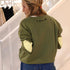 Classic green cotton fleece sweatshirt with Loved graphic at back neck and contrast imperfect heart elbow patches by Kerri Rosenthal.