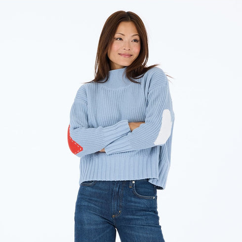 Marlow imperfect heart sweater is back in steel blue 100% cotton with a soft mock-neck and heart patchwork elbow - Shop cute sweaters by Kerri Rosenthal