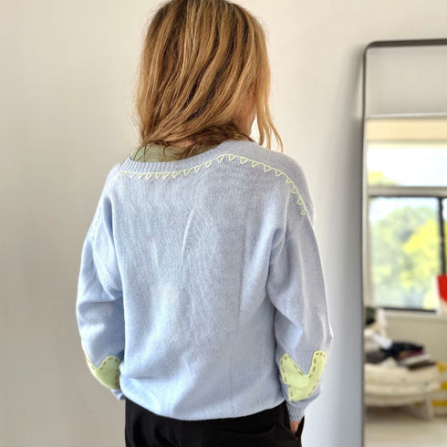 Light blue featherweight cashmere pullover with deep V neck heart elbow patches whipstitch back and on and on forever sleeve detail