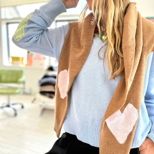 Womens light blue V neck cashmere sweater featuring whipstitch detailing and heart accents