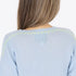 Featherweight blue V neck cashmere pullover with handwritten sleeve detail and elbow hearts