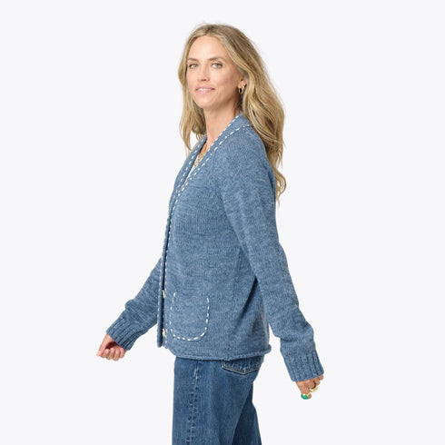 Back view of blue cardigan featuring tonal smiley design and detailed stitching