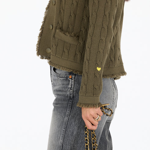 Army green cotton cardigan sweater fringe trim tonal imperfect heart artwork cable knit body and button front closure.