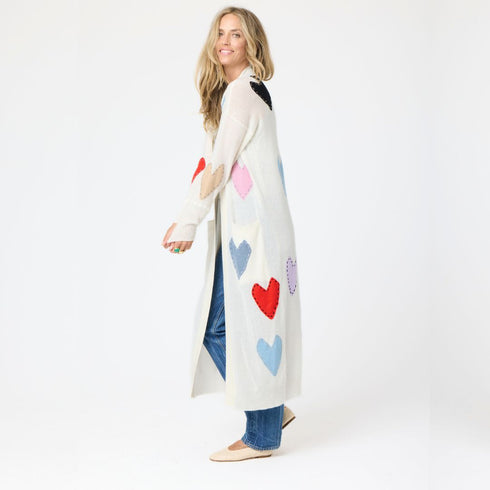 100% Cashmere long cardigan sweater duster with multicolored hand-stitched imperfect heart appliqués, front patch pockets, and ribbed cuffs.