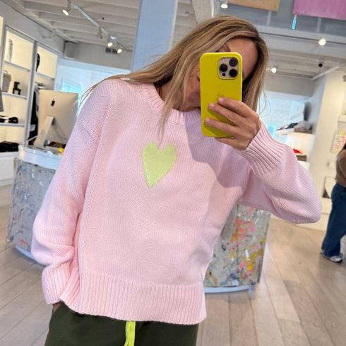 The Lovey light pink pullover sweater is made from 100% cotton with a contrast heart patch and relaxed fit - Shop cute women’s sweaters by Kerri Rosenthal