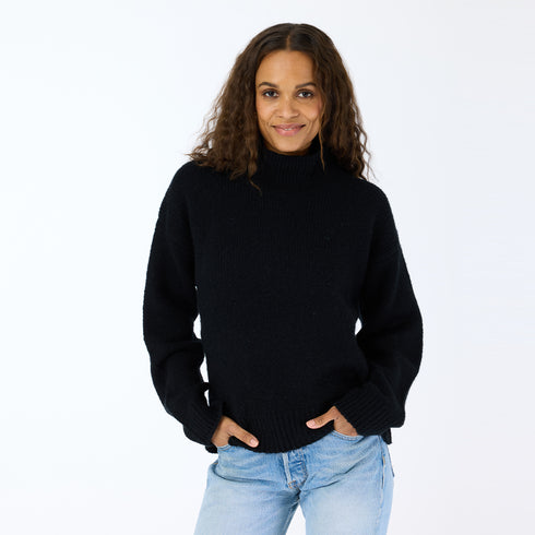 The Lucy mock-neck black sweater is made from a cashmere blend with heart patch elbows - Shop cute women’s sweaters by Kerri Rosenthal