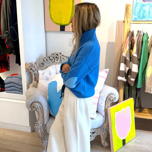 The Lucy mock-neck blue sweater is made from a cashmere blend with heart patch elbows - Shop cute women’s sweaters by Kerri Rosenthal