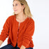Bassett rust cashmere cardigan, features a round neck, covered contrast buttons, and embroidered 'Loved' artwork - Cute women's cardigans by Kerri Rosenthal