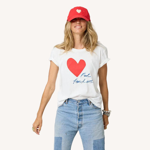 Suke white tee with Kerri's Imperfect Heart and 'Fool for Love' artwork in 100% cotton and red baseball cap hat.