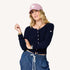 Charmed indigo blue button-down cashmere cardigan with an embroidered tiny heart and pink baseball cap hat by Kerri Rosenthal