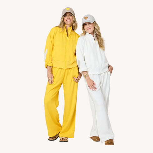 Zip-up mock neck cream and yellow sweatshirts in cotton loop terry with baseball cap hats by Kerri Rosenthal