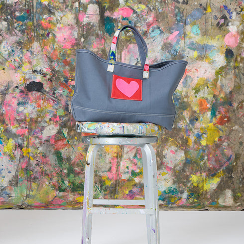 Love All Over french blue tote bag is made from 100% cotton canvas with a heart patch and a bag charm. Cute tote bags by Kerri Rosenthal