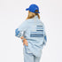 Denim shirt with imperfect heart elbow patches and blue american flag paired with light denim jeans