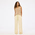 Beige wide leg palazzo pants in 100% cotton blend with beige sweater tank top and an elastic waist by Kerri Rosenthal