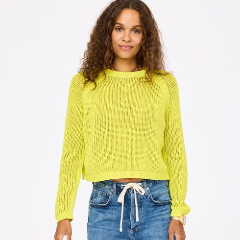 perfect summer open knit sweater in bright citron yellow on a brown haired woman