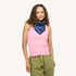 Woman wearing a pink tank top with a blue heart-print bandana scarf and army green drawstring pants.