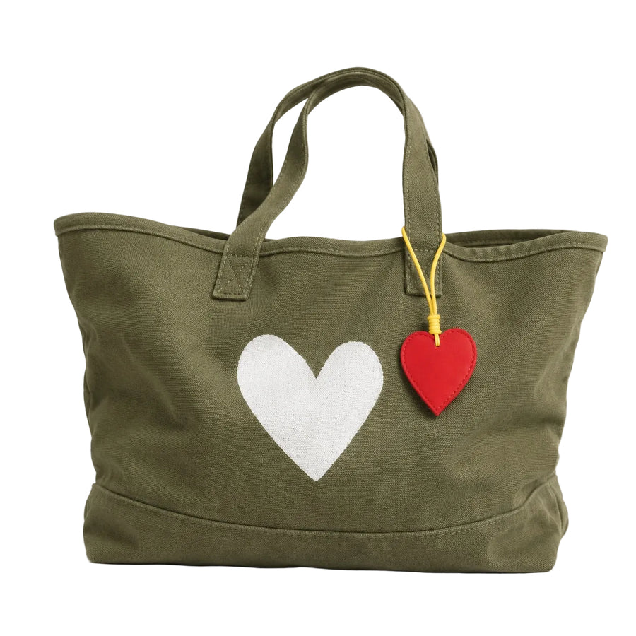 Olive green canvas tote bag with a white heart print and a red heart-shaped keychain charm.