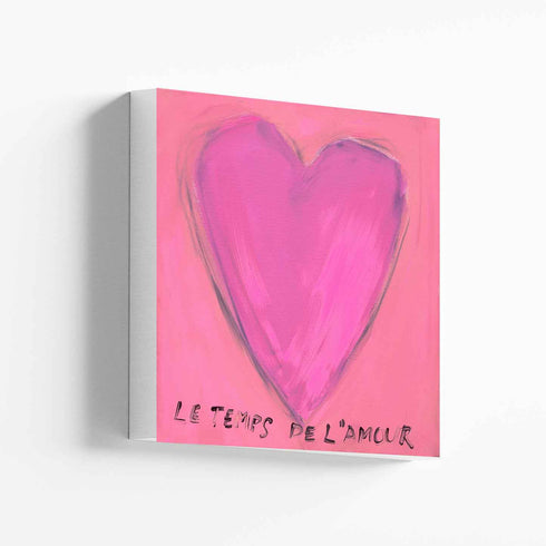 Le Temps de l'Amour art print: a magenta-pink heart on a pink background, with "Le Temps de l'Amour" hand-painted below it in black, printed on stretched canvas