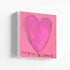 Le Temps de l'Amour art print: a magenta-pink heart on a pink background, with "Le Temps de l'Amour" hand-painted below it in black, printed on stretched canvas