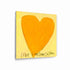 Love Looks Good on You art print: a bold orange heart with an angular shape on a pale yellow background, with "Love Looks Good On You" hand-painted below it in black, printed on brushed aluminum