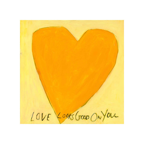 Love Looks Good on You art print: a bold orange heart with an angular shape on a pale yellow background, with "Love Looks Good On You" hand-painted below it in black, shown as an unframed print